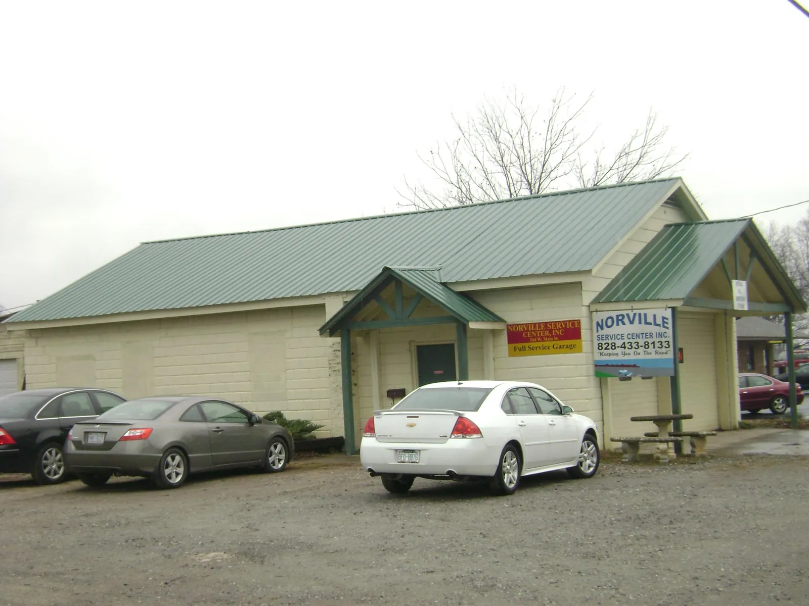 Green metal roof on a service garage with a covered entry in Fort Covington